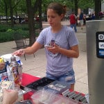 Mobile hot dog vendor accepts a credit card payment with a Square reader.
